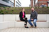 2 colleagues sitting on a bench